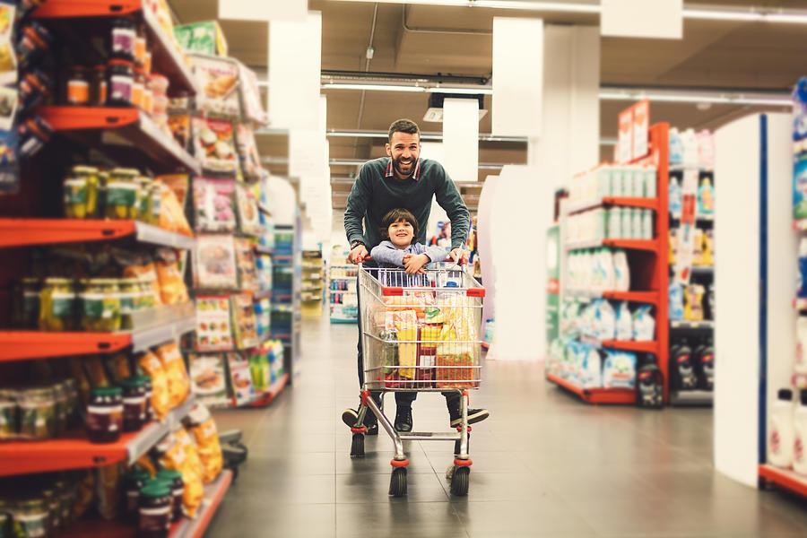 Father and Son In A Supermarket. #2 Photograph by Vgajic