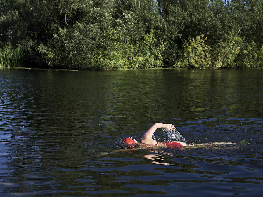 Female wild swimmer in River Great Ouse #2 Photograph by Gary Yeowell