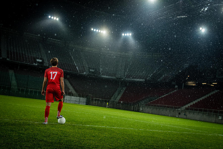 Football player standing in stadium #2 Photograph by Simonkr