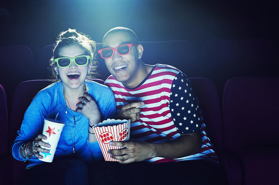 Friends at the cinema wearing 3D glasses #2 Photograph by Flashpop