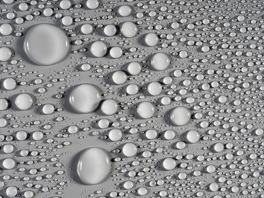 Full frame of the textures formed by the bubbles and drops of water, on a smooth  gray background. #2 Photograph by Jose A. Bernat Bacete