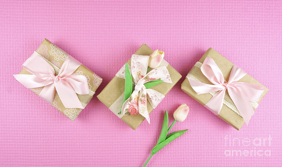 Gifts wrapped in kraft paper and pink ribbons overhead flatlay. #2 Photograph by Milleflore Images
