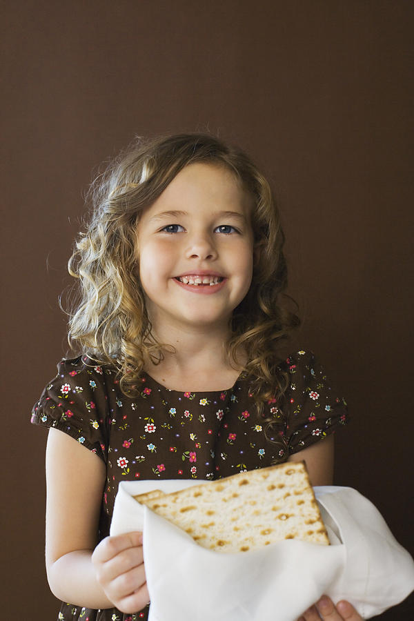 Girl holding matzoh #2 Photograph by Jupiterimages