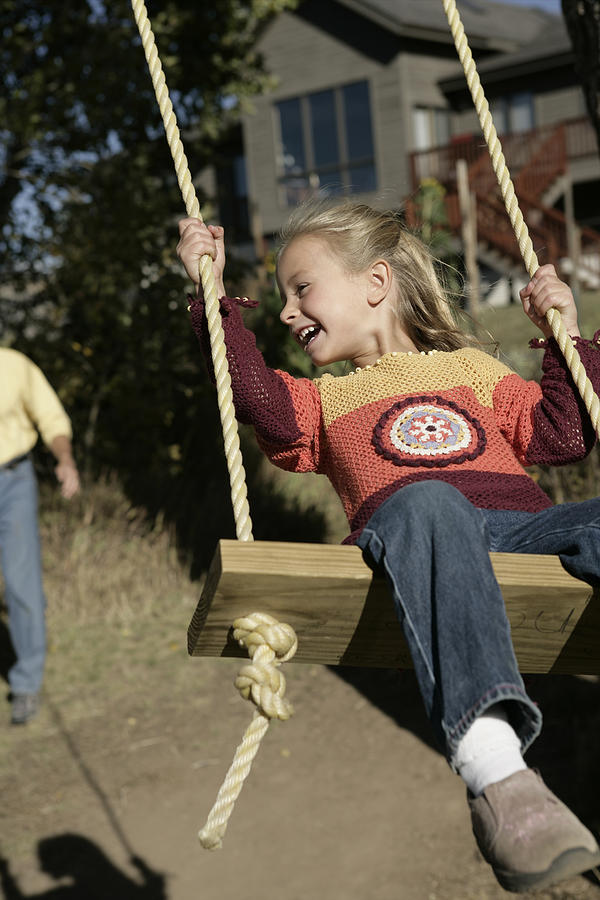 Girl swinging #2 Photograph by Comstock Images