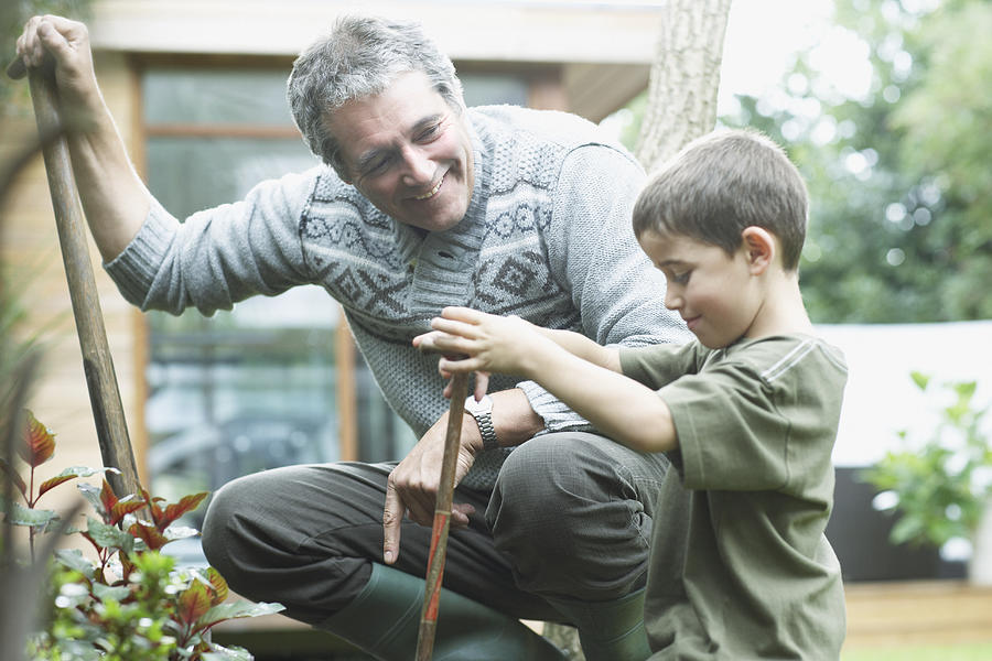Grandfather and grandson gardening #2 Photograph by Sam Edwards