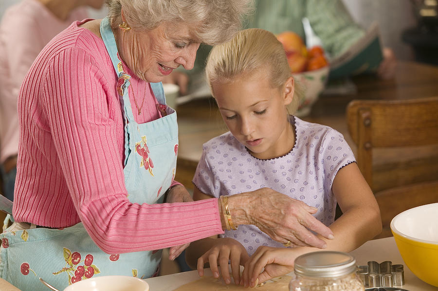 Grandmother and granddaughter baking #2 Photograph by Comstock Images