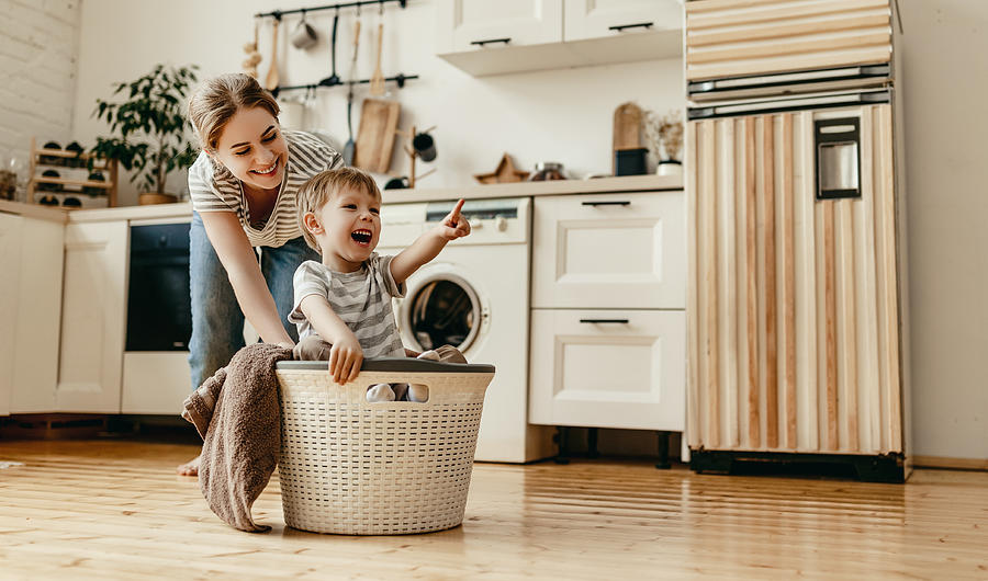 Happy family mother housewife and child   in laundry with washing machine #2 Photograph by Evgenyatamanenko