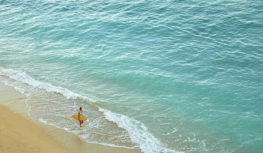 High angle view of Pacific Islander woman carrying surfboard on beach #2 Photograph by Colin Anderson Productions pty ltd