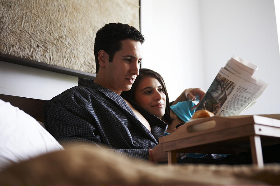 Hispanic couple in luxury bedroom #2 Photograph by Chris Clinton
