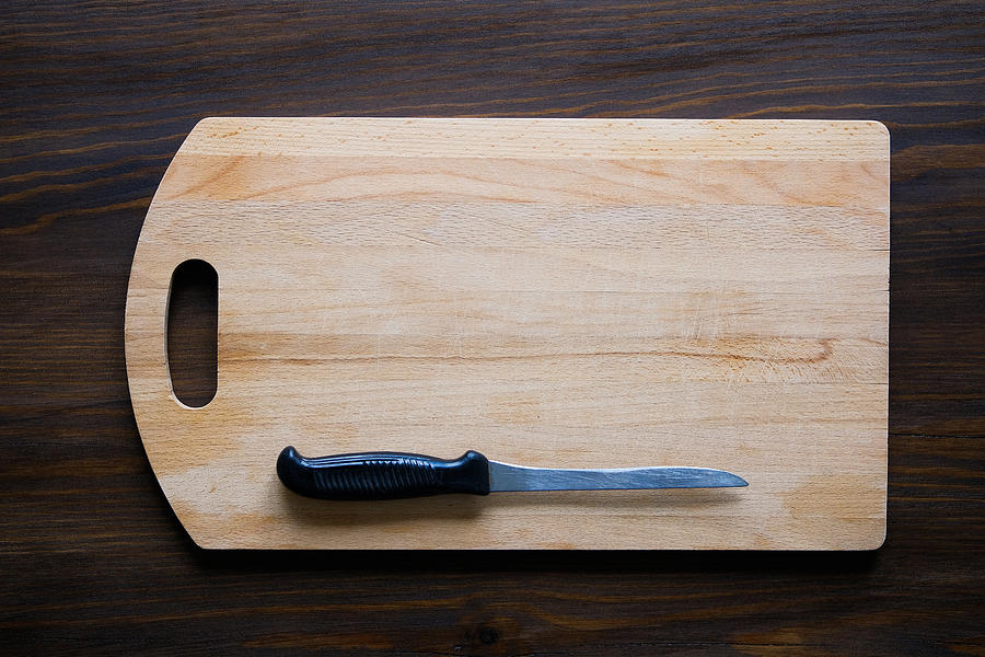 Kitchen knife with black plastic handle on a wooden cutting Board, close-up. Copy space for text. The concept of kitchen utensils, cooking. #2 Photograph by Aleksandr Zubkov