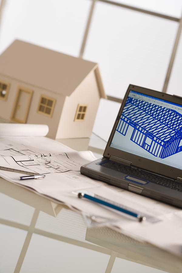 Laptop, model house, and blueprints #2 Photograph by Comstock Images