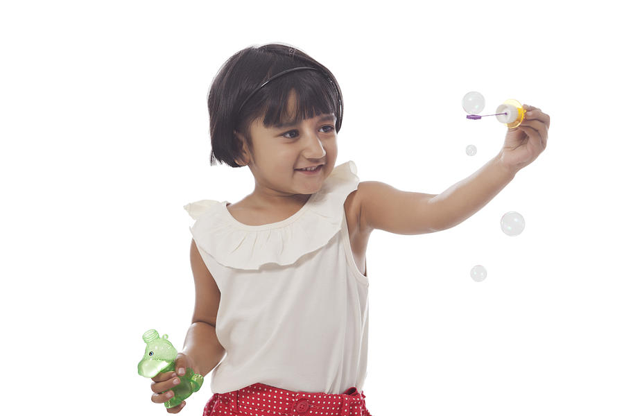 Little girl making bubbles #2 Photograph by IndiaPix/IndiaPicture