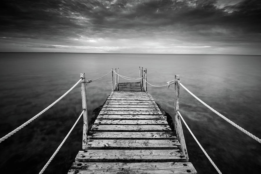 Long wooden pier in the sea at sunset. #2 Photograph by Michalakis Ppalis