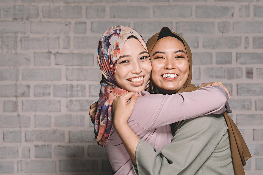 2 Malay Female Hugging And Having Fun Looking At Camera Photograph by Chee Gin Tan