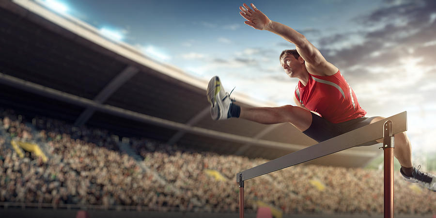 Male athlete hurdling on sports race #2 Photograph by Dmytro Aksonov