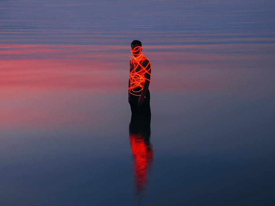 Man entangled with neon wires against sea background #2 Photograph by Vasilina Popova