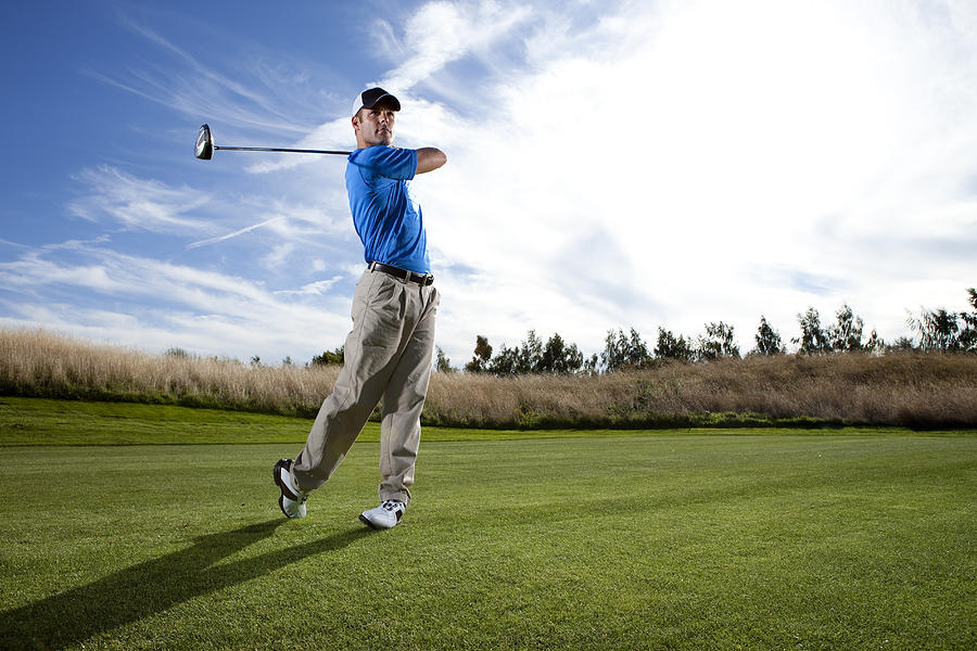 Man hitting a ball on the golf course. #2 Photograph by Jordan Siemens