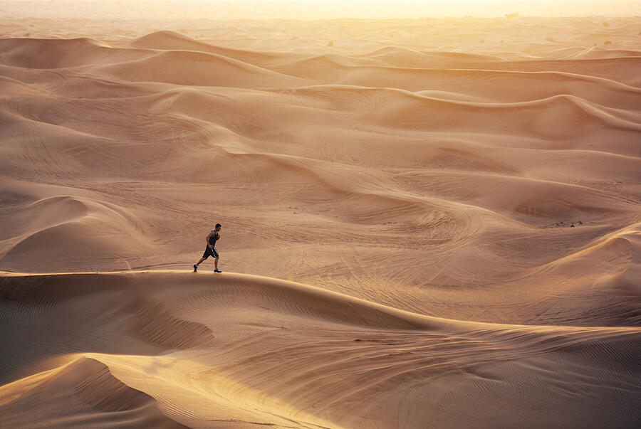 Man running in sand dunes #2 Photograph by David Trood