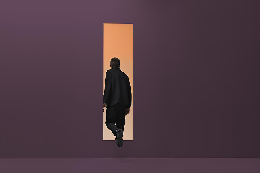 Man walking threw rectangular opening in coloured room #2 Photograph by Klaus Vedfelt
