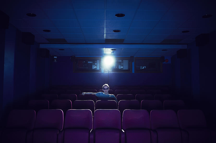Man watching a movie in empty cinema #2 Photograph by Flashpop
