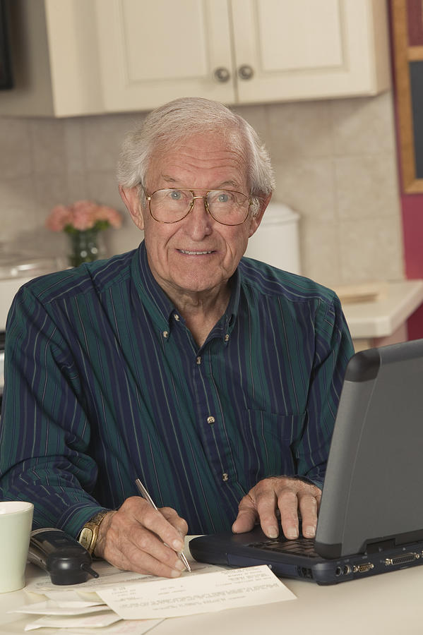 Man writing and using laptop #2 Photograph by Comstock Images
