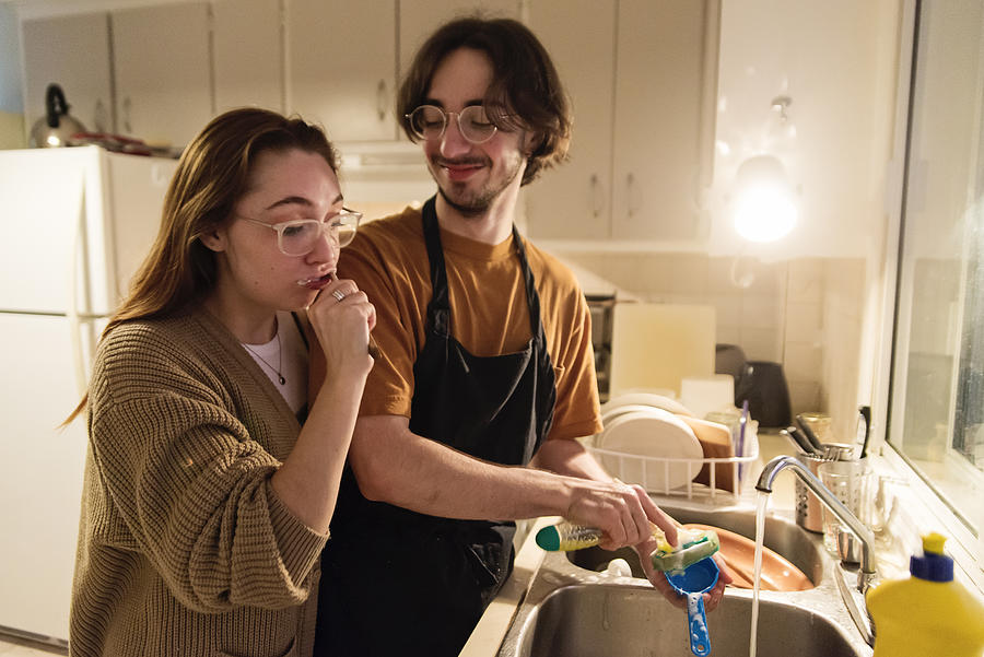 Millennial couple of students shared living doing chores. #2 Photograph by Martinedoucet