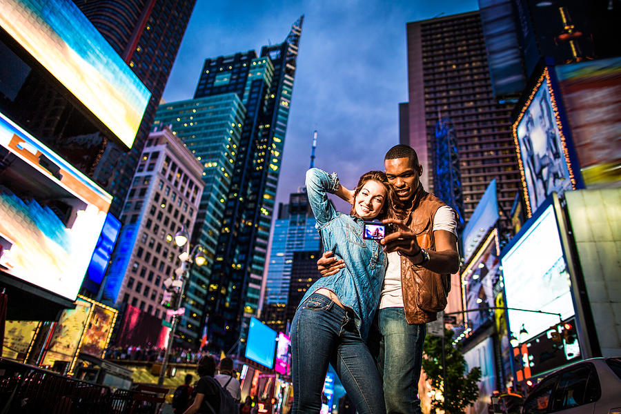 Mixed race couple walking around in New York City, taking selfies #2 Photograph by Itsskin