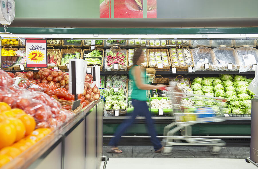 Mixed race woman shopping for vegetables #2 Photograph by Jacobs Stock Photography Ltd