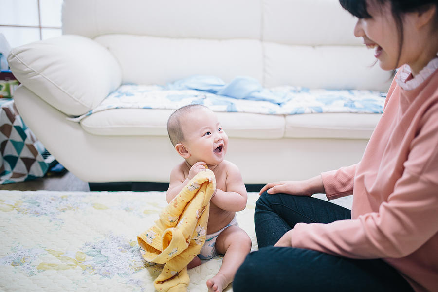 Mother and baby playing in living room #2 Photograph by Insung Jeon