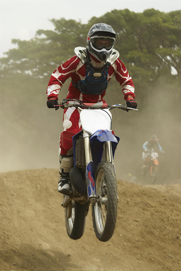 Motocross rider performing a jump on a motorcycle #2 Photograph by Glowimages