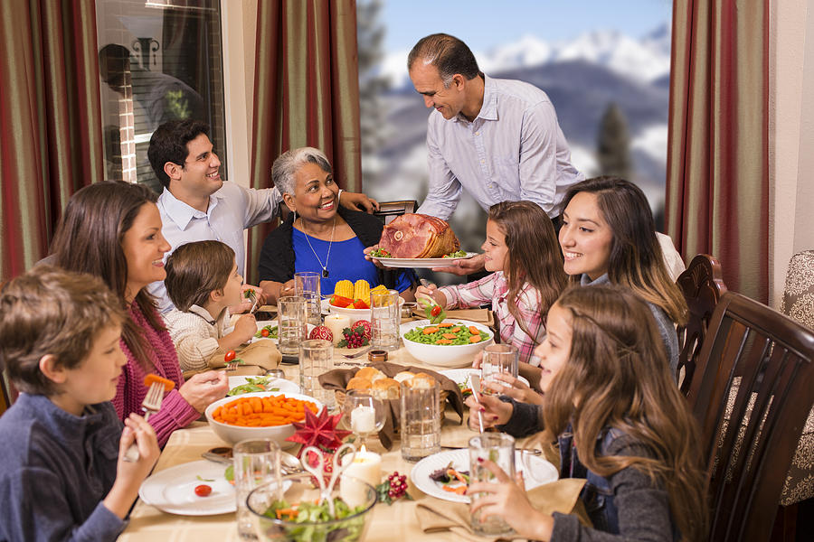 Multi-ethnic family enjoying Christmas dinner at grandmothers home. #2 Photograph by Fstop123