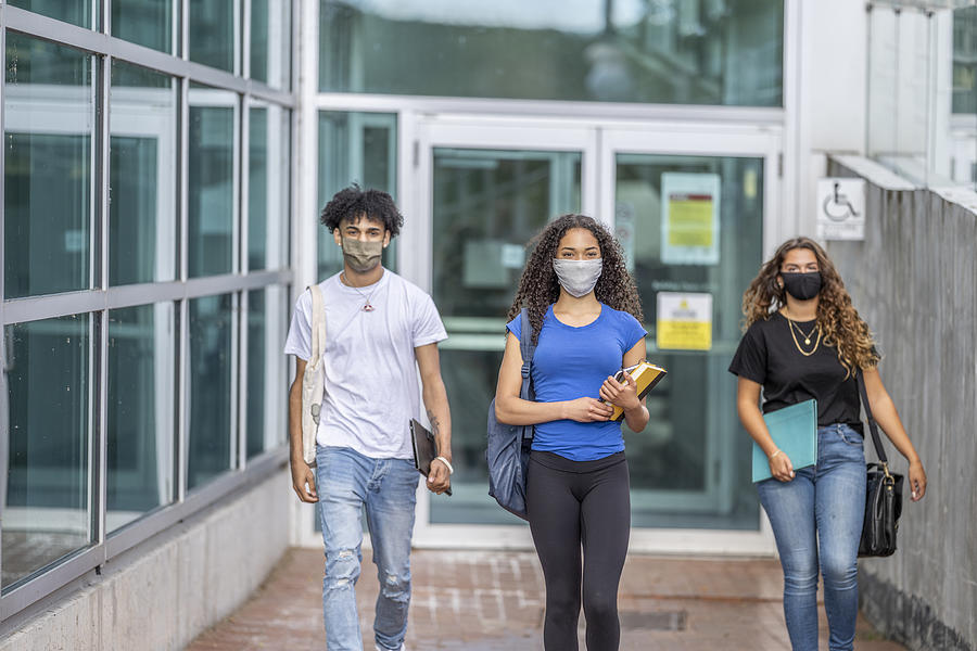 Multi-ethnic group of students wearing masks on campus #2 Photograph by FatCamera