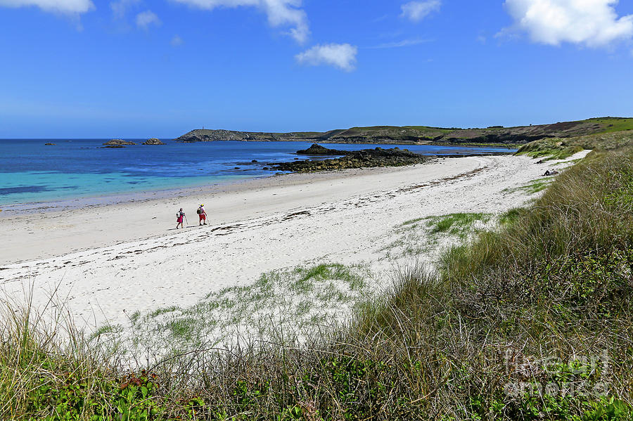 2 people walking on an almost deserted beach at Great Bay in St  Photograph by John Keates
