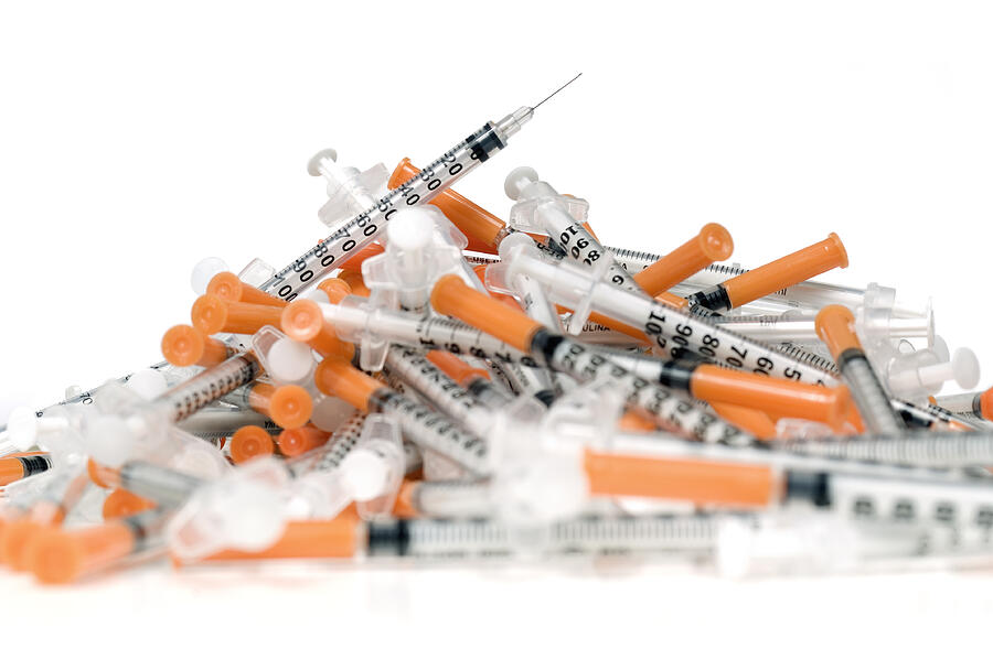 Pile of used syringes on white #2 Photograph by Stockcam