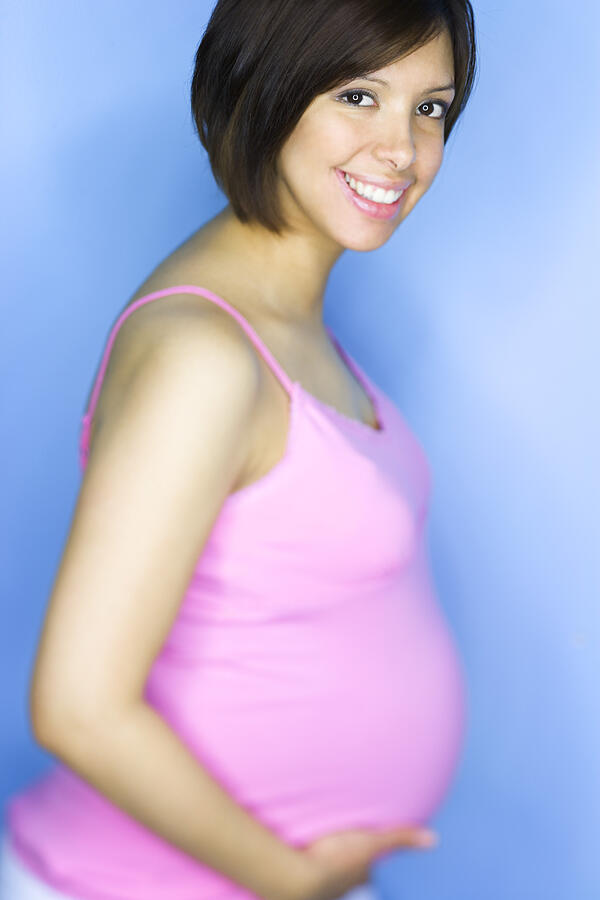 Portrait of a young pregnant woman smiling #2 Photograph by Photodisc