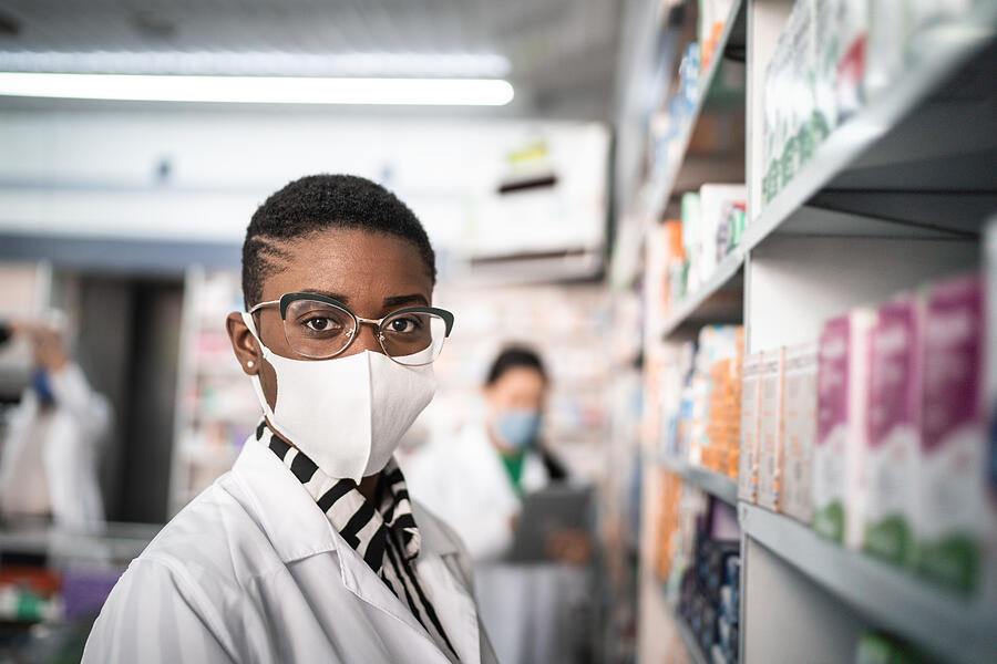 Portrait of female pharmacist with face mask at pharmacy #2 Photograph by FG Trade