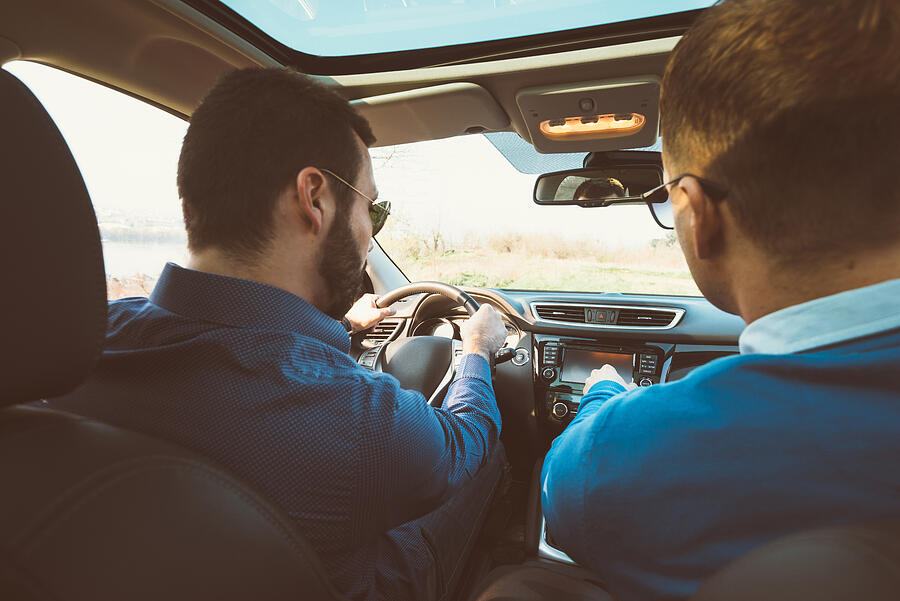 Portrait of two handsome men in car driving for holiday #2 Photograph by Drazen_