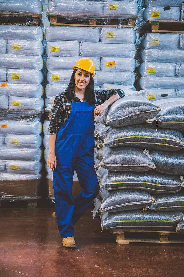 Portrait of young confident female worker in factory warehouse #2 Photograph by Serts