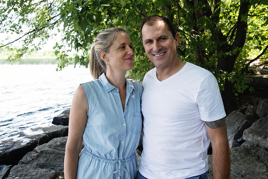 Real couple in theirs forties portrait on riverside in summer. #2 Photograph by Martinedoucet