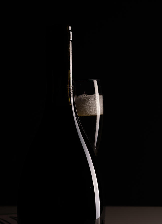 Red Sparking Wine On A Wineglass And Black Wine Bottle. Photograph