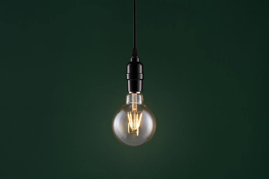 Retro Style Light Bulb on Dark Green #2 Photograph by MirageC
