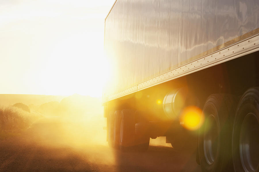 Semi-truck driving on dirt road #2 Photograph by Martin Barraud