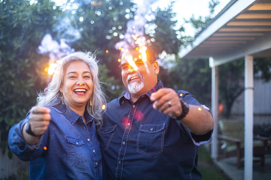 Senior Mexican Couple holding Sparklers Together #2 Photograph by Adamkaz