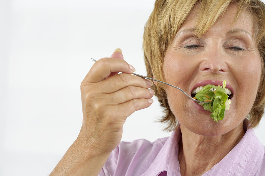 Senior woman eating salad #2 Photograph by Stock4b-rf