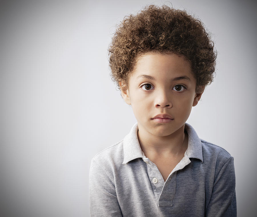 Serious mixed race boy with curly hair #2 Photograph by Jose Luis Pelaez Inc