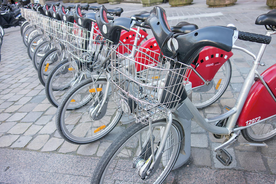 Shared bikes are lined up in the streets of Lyons, France. Photograph ...