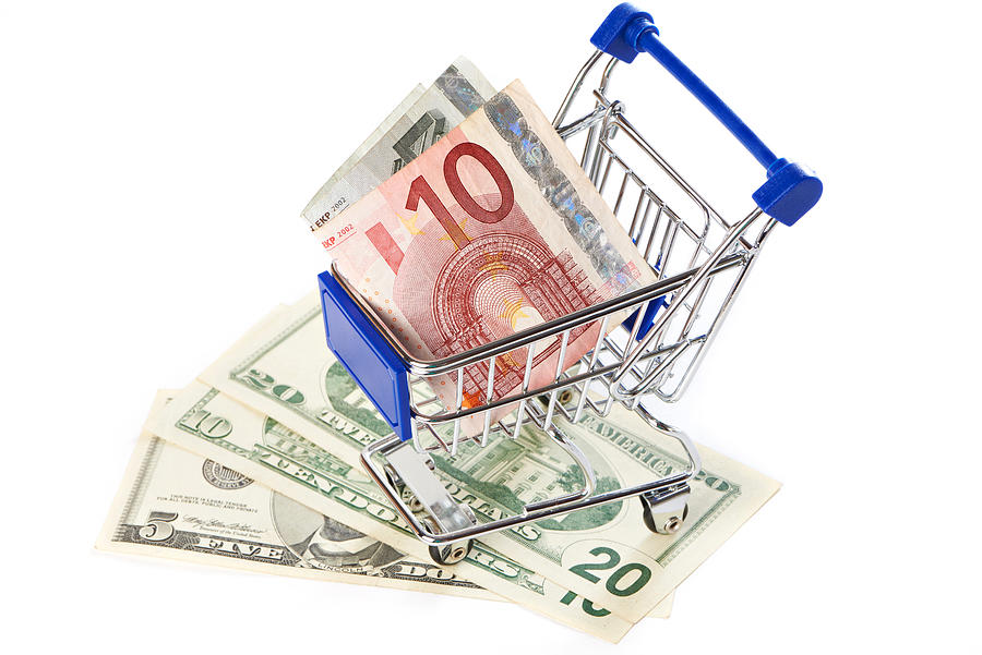 Shopping trolley with money isolated #2 Photograph by Sergeyryzhov