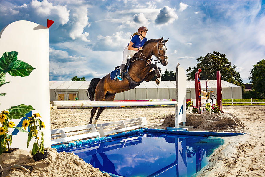 Show jumping - horse with female rider jumping over hurdle #2 Photograph by Zocha_K