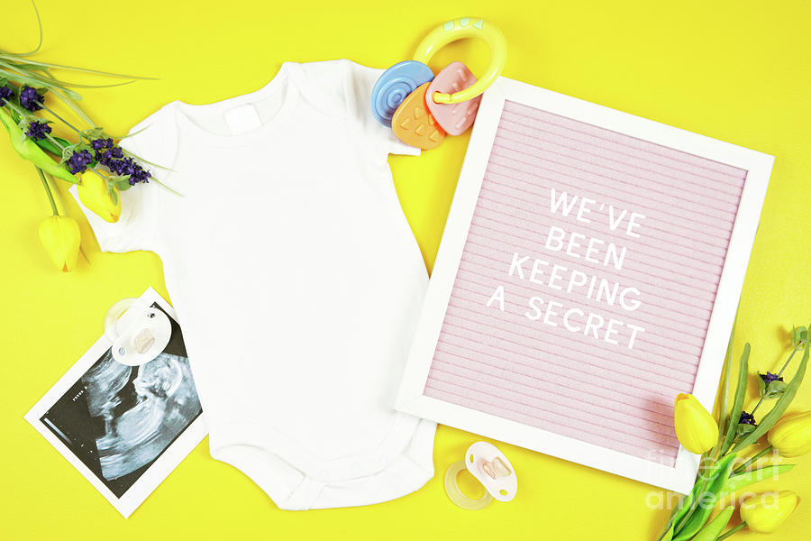 Springtime baby apparel flatlay top view on yellow table. Mock up. #2 Photograph by Milleflore Images