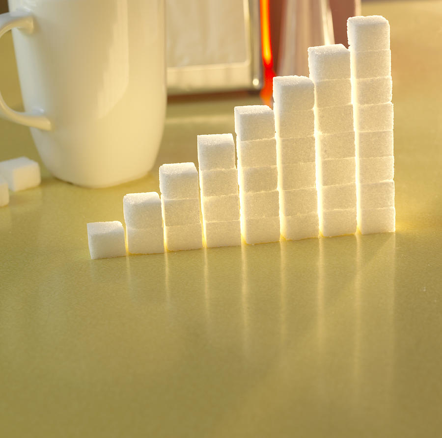 Stack of sugar cubes in the shape of a graph on a yellow table #2 Photograph by Daniel Allan